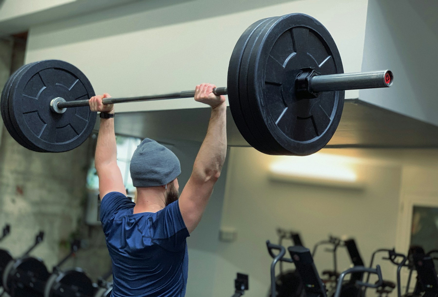 A person training with a barbell in a gym
